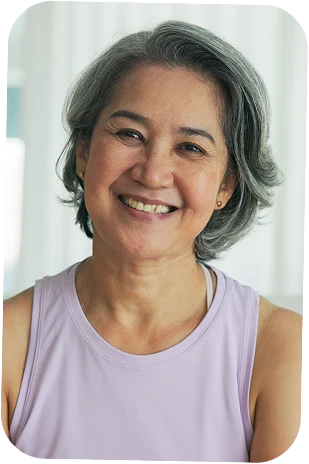 A woman with a purple singlet smiling at the camera
