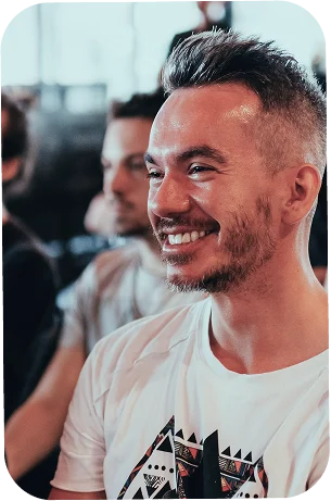 A man smiling in a crowd