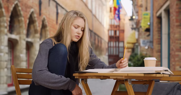 A woman sitting outside studying