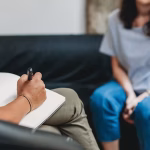 A therapist taking notes during a session