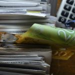 A close up of letters, money and a calculator