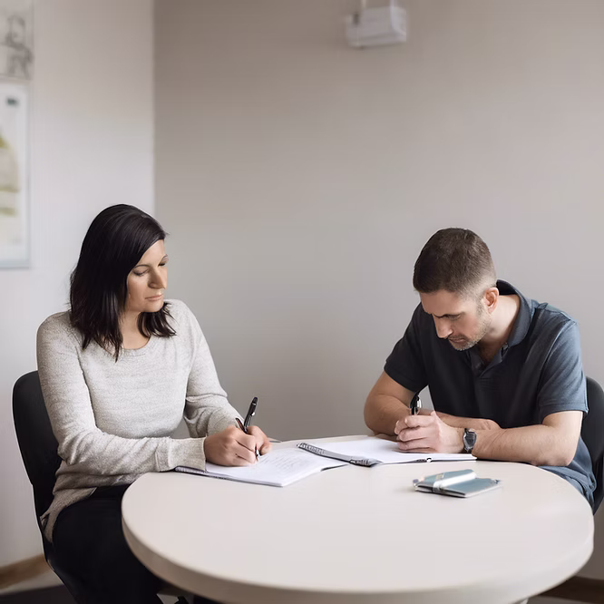 A therapist and client sitting at a table