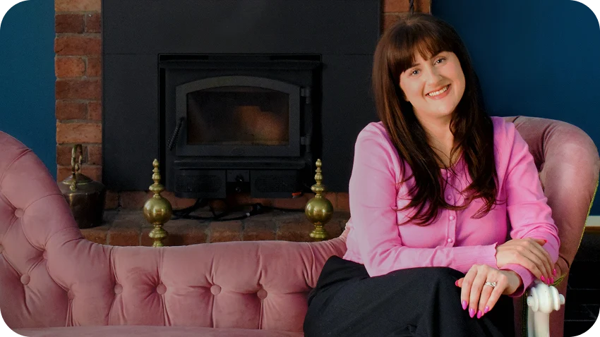 Amanda Moses sitting on a pink lounge