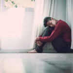 A man sitting on the floor