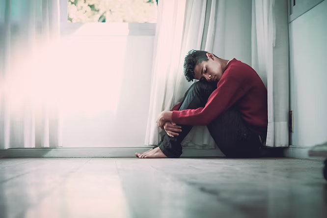 A man sitting on the floor
